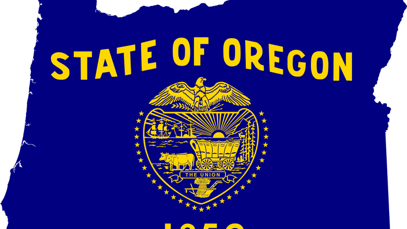 flag of oregon over state map