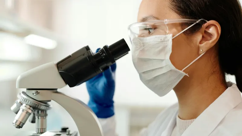 scientist looking into a microscope