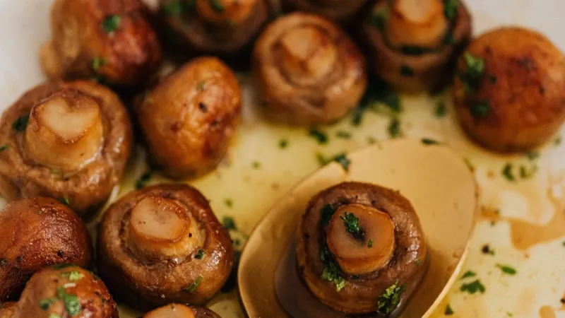 Tantalizing close-up of savory roasted mushrooms with herbs on a plate