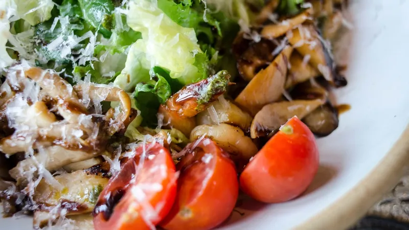 Close-up of a fresh mixed salad with cherry tomatoes, lettuce, and mushrooms