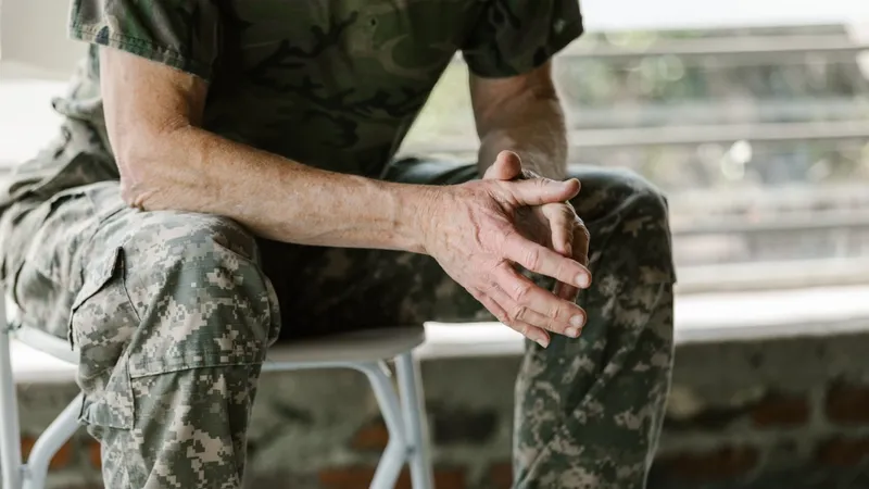Close-up of a military veteran's hands in a therapy session, emphasizing mental health support