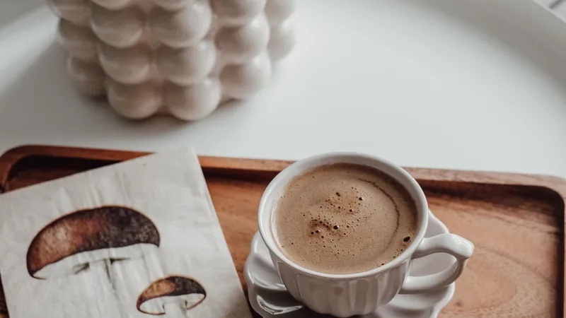 Modern coffee setup with unique mushroom coffee napkin and plant for a cozy feel.
